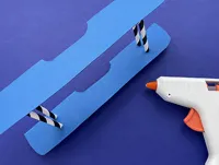 The lower and upper wing of the plane glued together in parallel by two straws, cut down to the desired height.