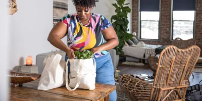 Woman opening reusable grocery bag