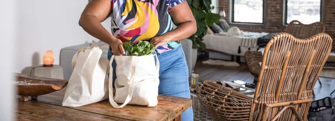 Woman opening reusable grocery bag