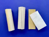 2 different width cardboard tubes on a blue background with a single piece of kitchen paper and piece of gummy tape.