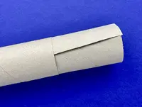 A piece of kitchen paper cardboard cut lengthways is shown partially, tucked inside an uncut piece on a blue background.
