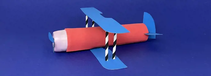 A cardboard airplane made out of a paper tube, cardboard, straws, and other recycled materials.